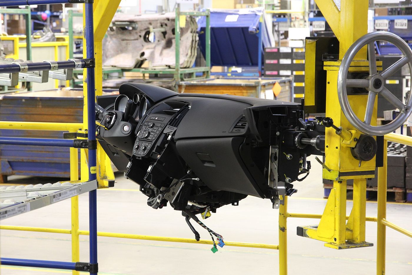 Robots weld car bodies on an assembly line. Carmakers have announced 11 billion euros of hybrid and combustion investment in Europe this year.