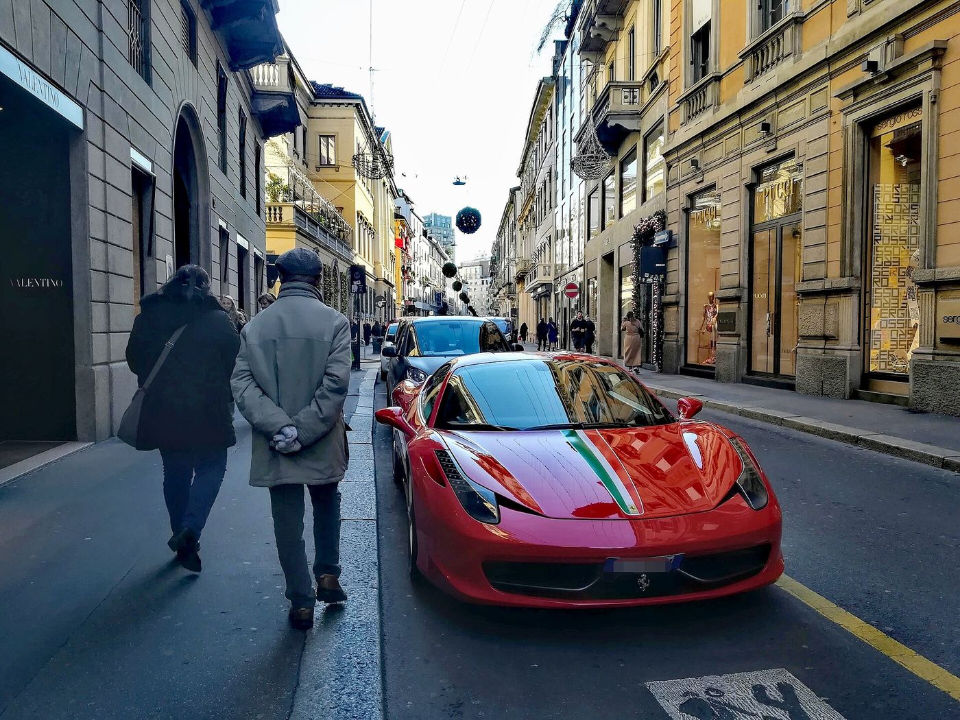 Shop windows on Via Montenapoleone in Milan’s luxury district, where three storefronts are currently papered over.