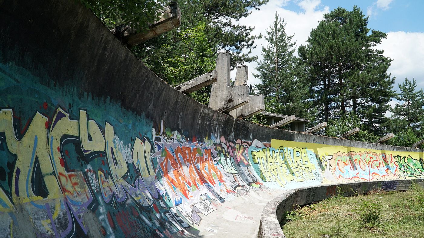 An ice-covered curve of a bobsled and luge track. Cortina’s Olympic track faces a debate over its future.